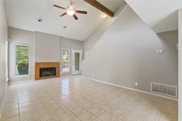 a view of a livingroom with a fireplace and chandelier fan