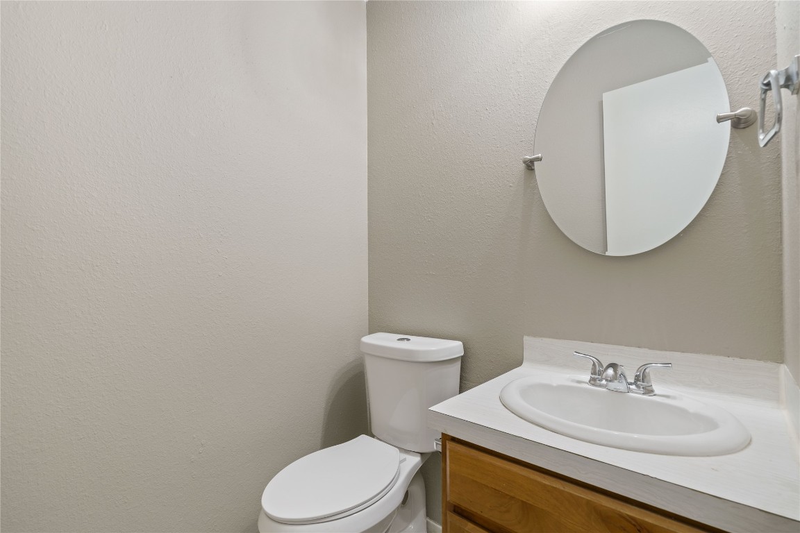 8005 Hood Circle, Unit B Austin, TX 78745 - Photo 10 of 18 a bathroom with a toilet a sink and mirror