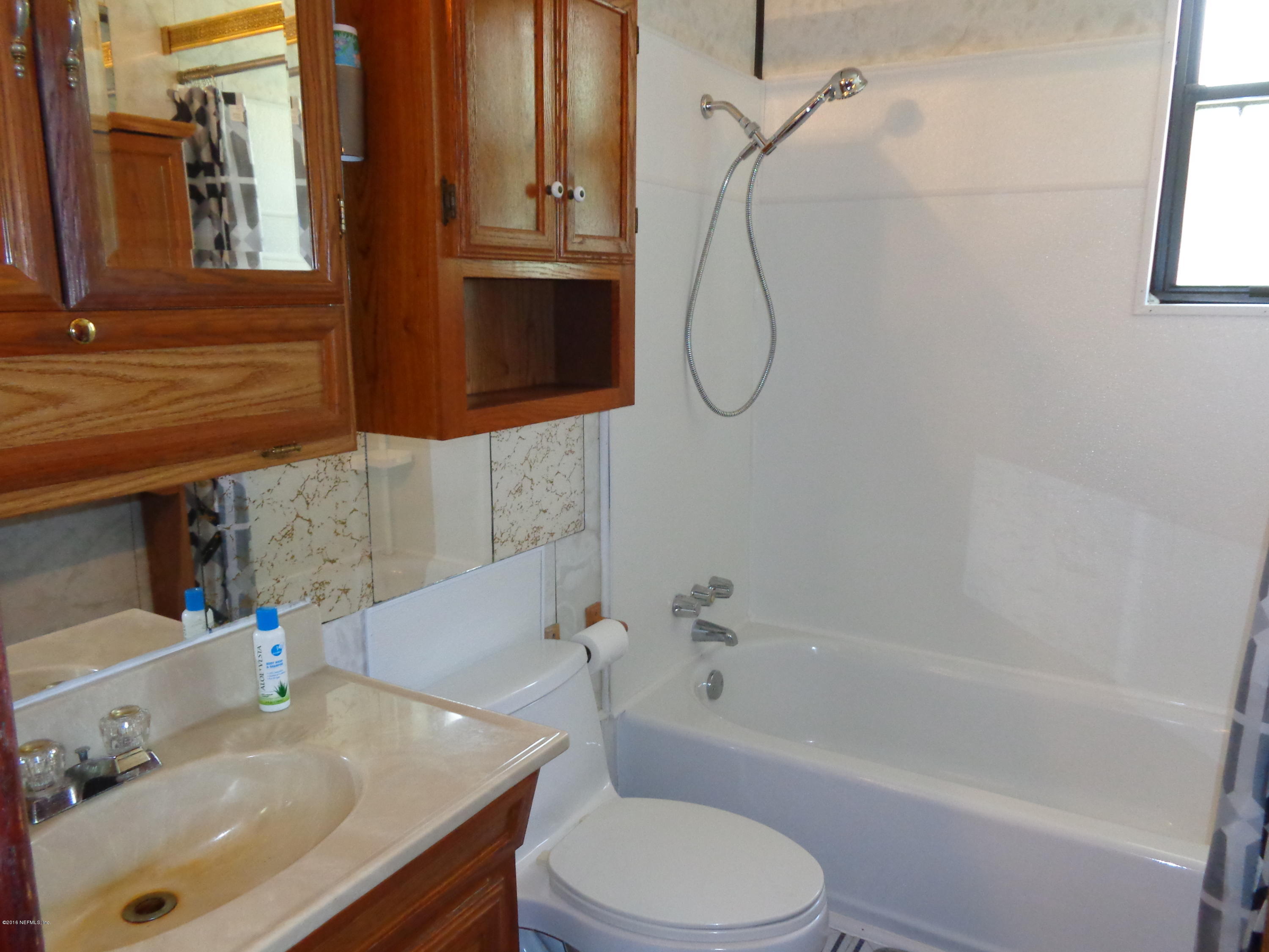 13294 Yellow Bluff Road Jacksonville, FL 32226 - Photo 13 of 21 a bathroom with a sink a toilet and shower