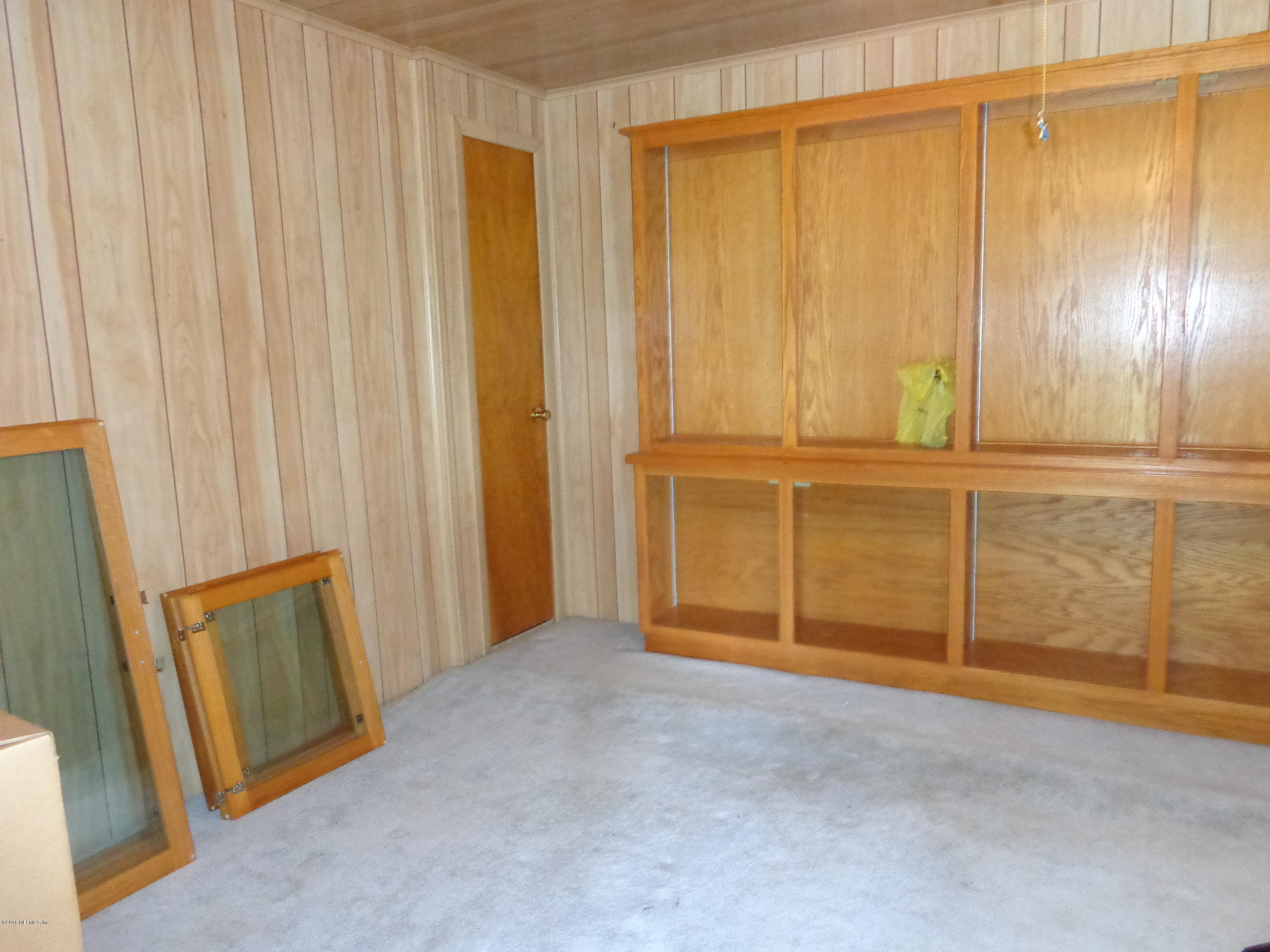 13294 Yellow Bluff Road Jacksonville, FL 32226 - Photo 14 of 21 a view of an empty room with wooden door