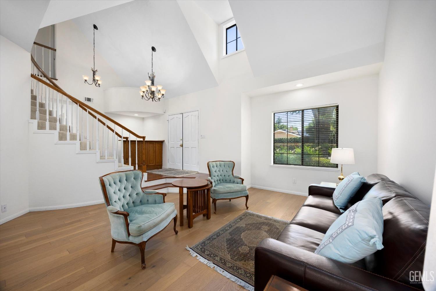Undisclosed Address Bakersfield, CA 93309 - Photo 11 of 48 a living room with furniture and a chandelier