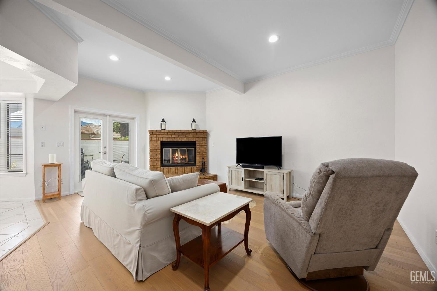 Undisclosed Address Bakersfield, CA 93309 - Photo 14 of 48 a living room with furniture a flat screen tv and a fireplace