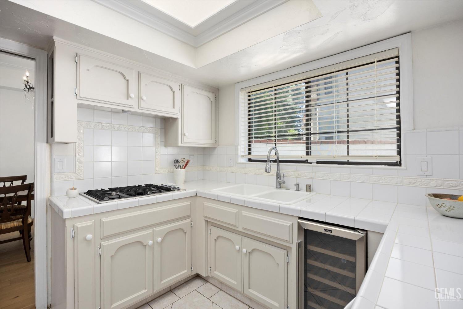 Undisclosed Address Bakersfield, CA 93309 - Photo 19 of 48 a kitchen with white cabinets appliances a sink and a window