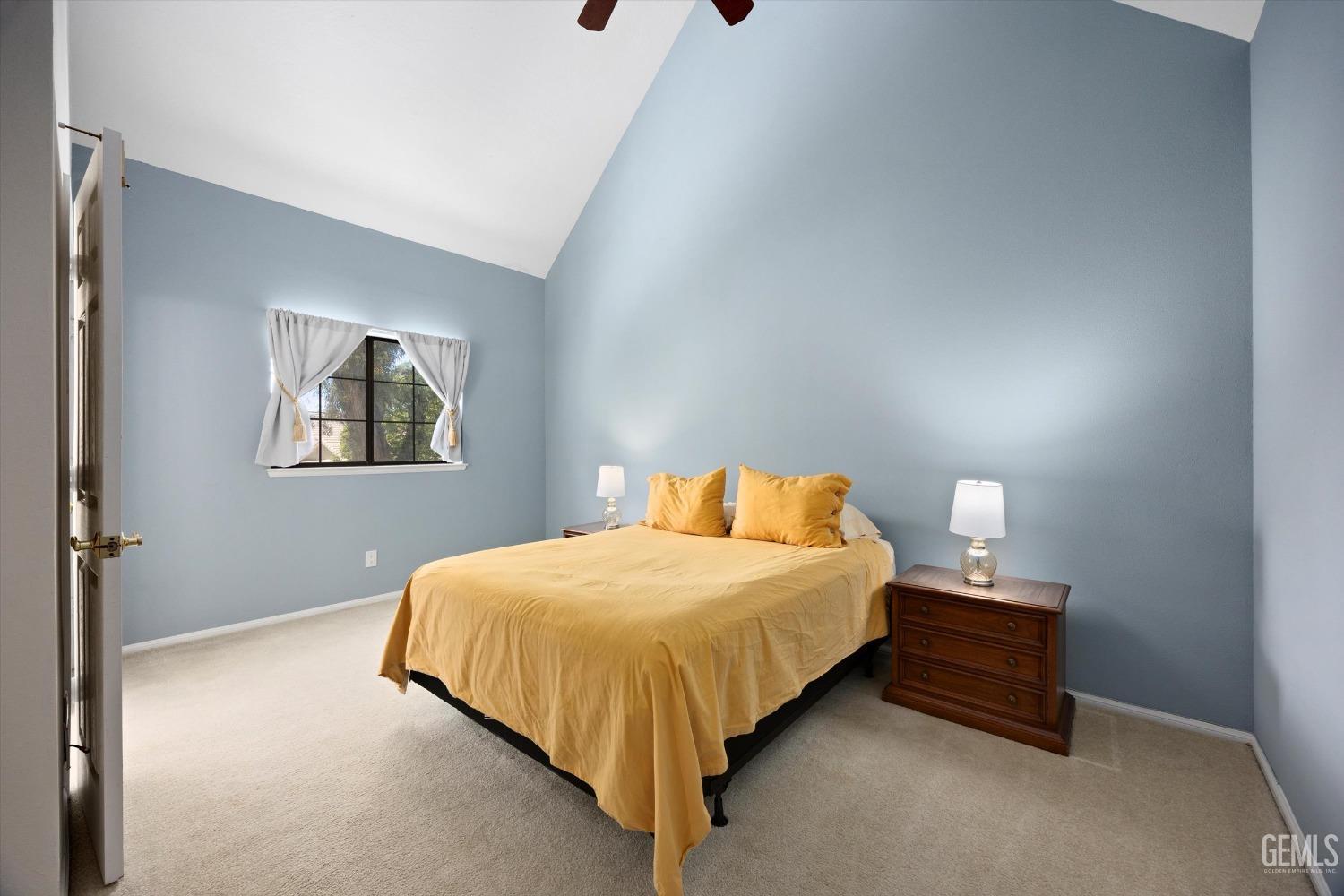 Undisclosed Address Bakersfield, CA 93309 - Photo 24 of 48 a bedroom with a bed and a lamp on table