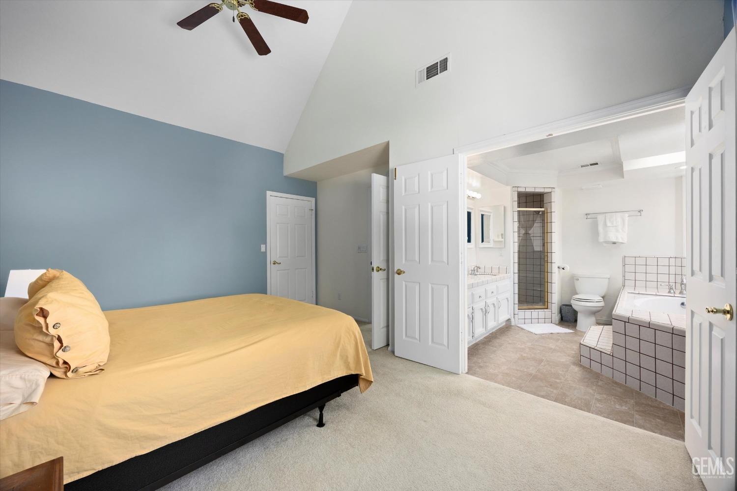 Undisclosed Address Bakersfield, CA 93309 - Photo 25 of 48 a bedroom with a bed and a chandelier