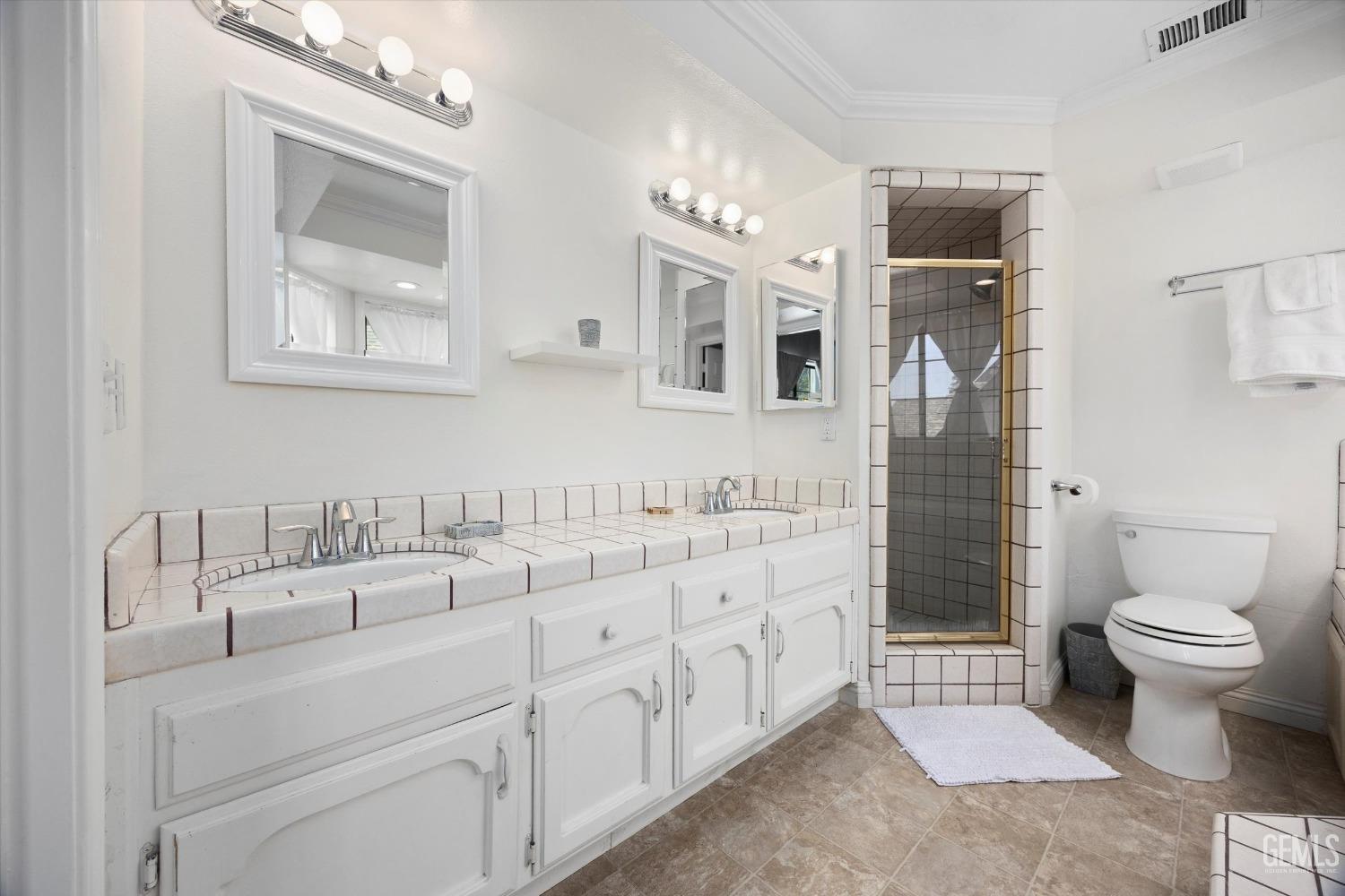 Undisclosed Address Bakersfield, CA 93309 - Photo 27 of 48 a bathroom with double sink and a toilet