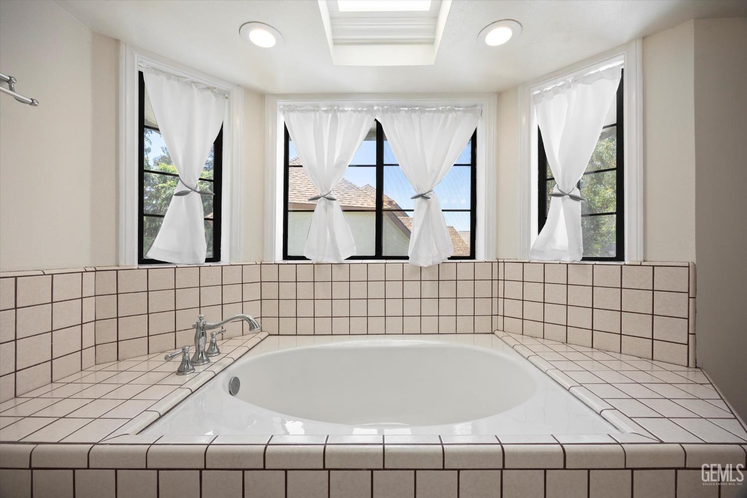 Undisclosed Address Bakersfield, CA 93309 - Photo 28 of 48 a bathroom with a bathtub and a shower