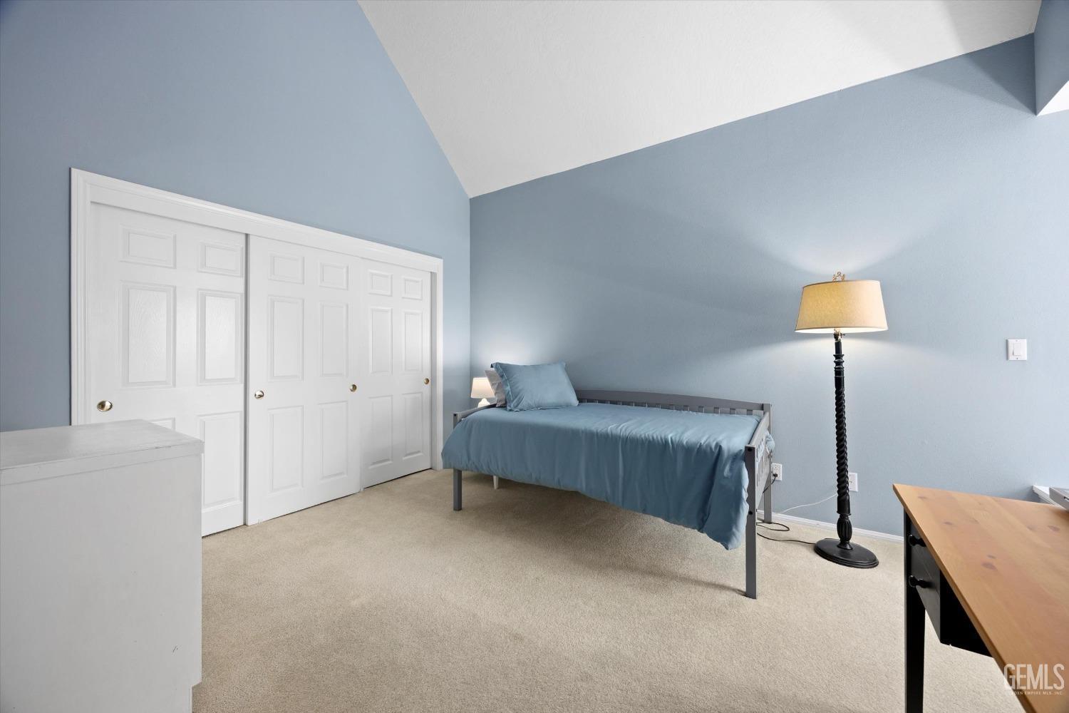 Undisclosed Address Bakersfield, CA 93309 - Photo 29 of 48 a bedroom with a bed and a lamp