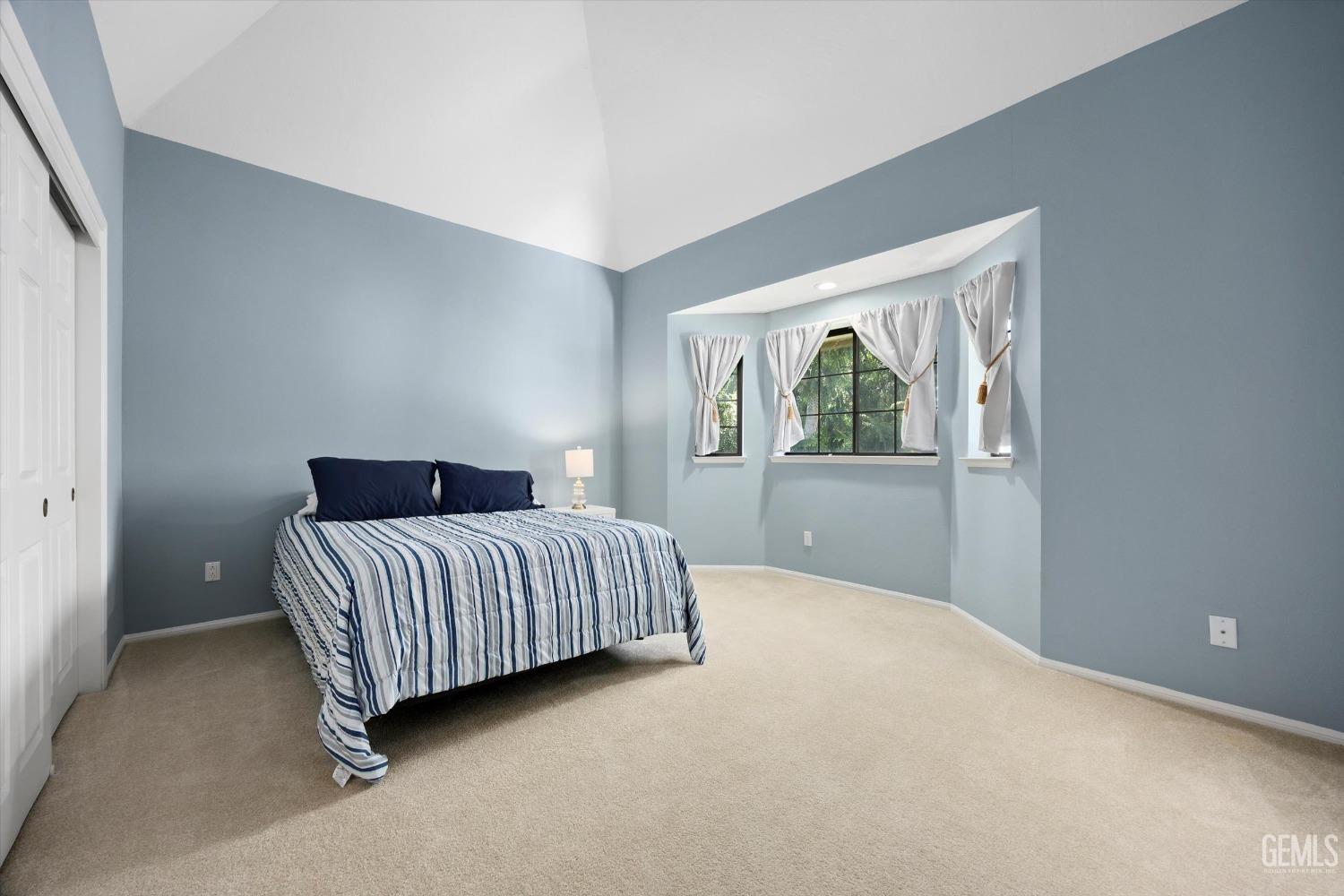 Undisclosed Address Bakersfield, CA 93309 - Photo 32 of 48 a spacious bedroom with a bed and a window