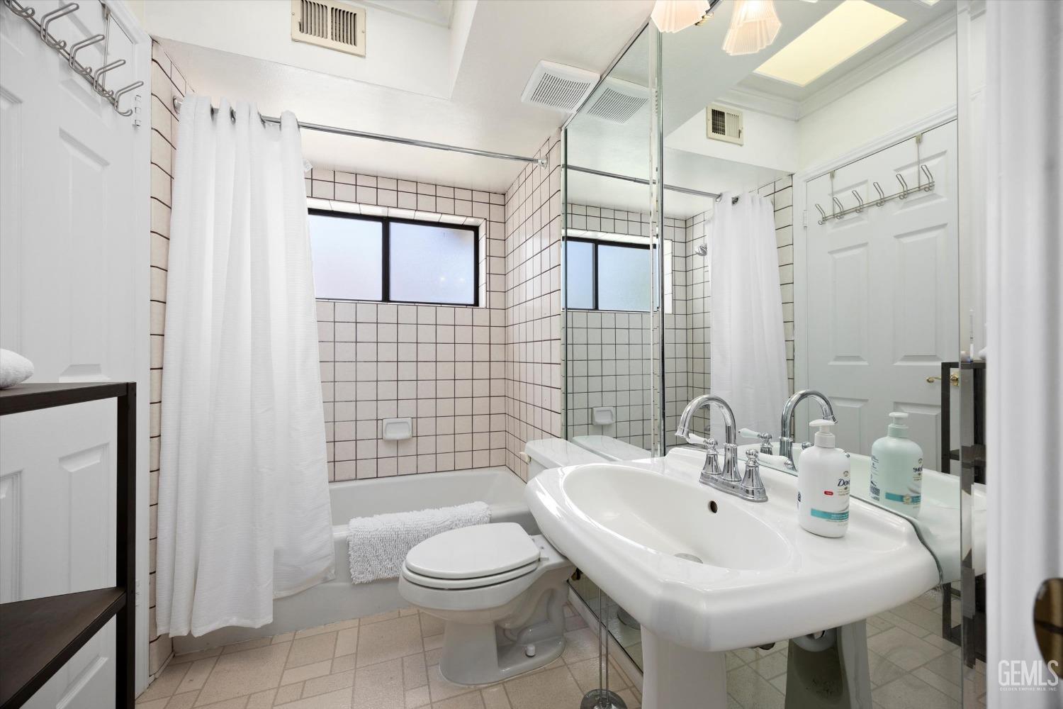 Undisclosed Address Bakersfield, CA 93309 - Photo 33 of 48 a bathroom with a sink a toilet and shower