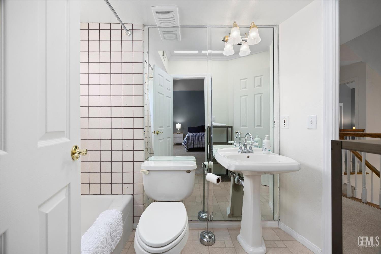 Undisclosed Address Bakersfield, CA 93309 - Photo 34 of 48 a white toilet sitting next to a bathroom sink