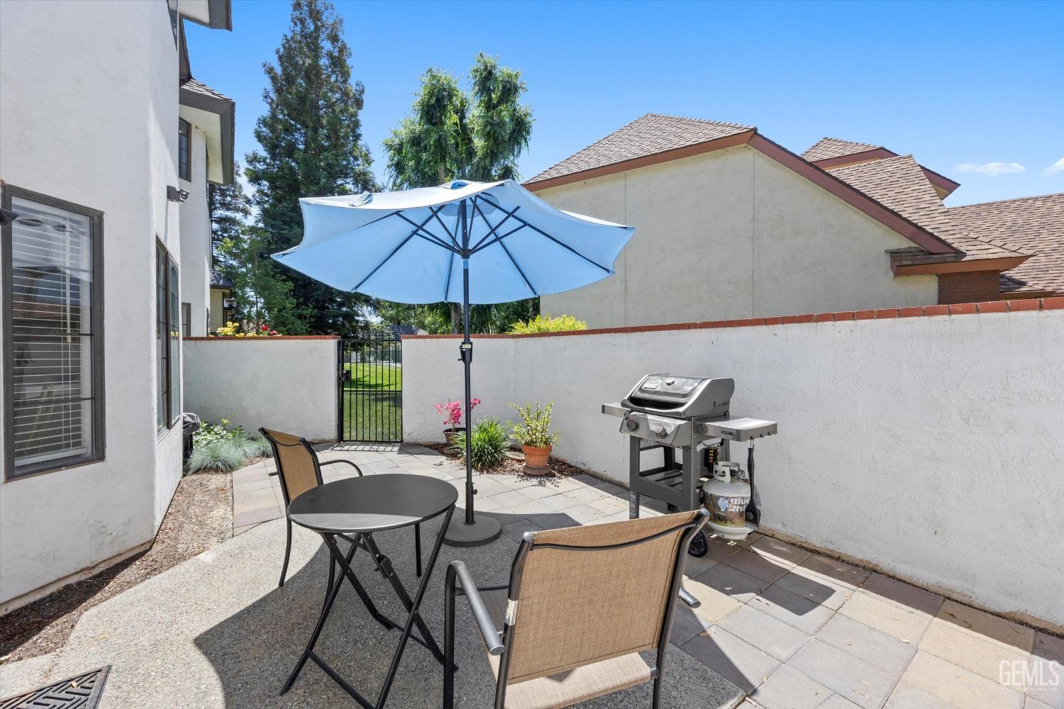 Undisclosed Address Bakersfield, CA 93309 - Photo 36 of 48 a patio table and chairs under an umbrella