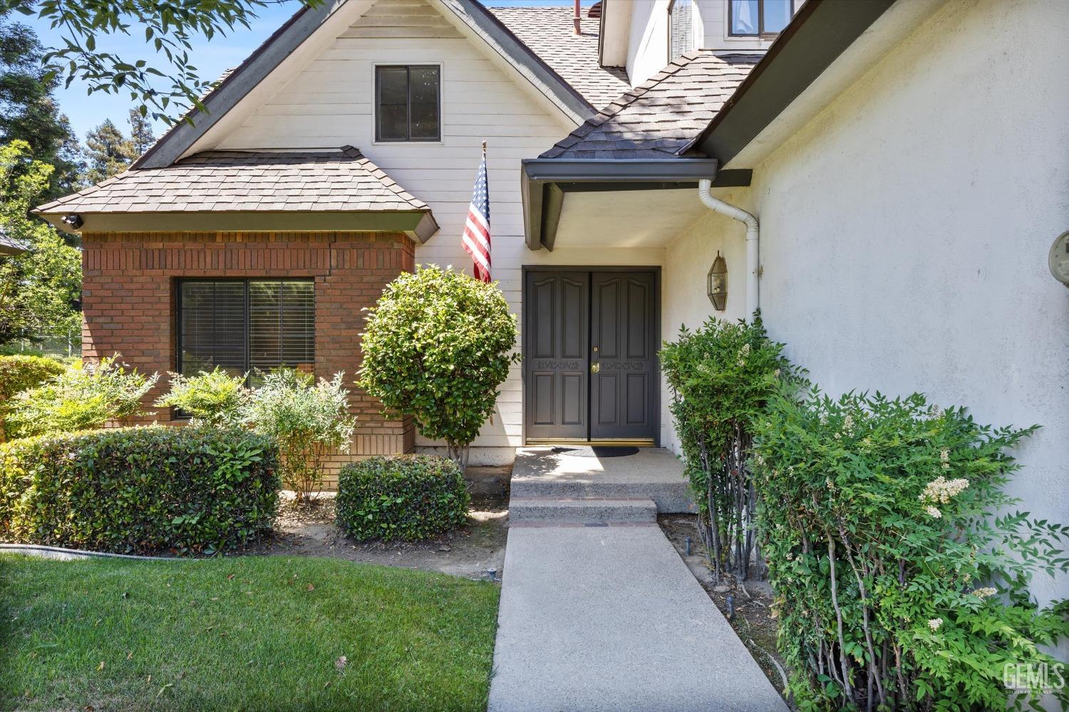 Undisclosed Address Bakersfield, CA 93309 - Photo 5 of 48 a front view of a house with a garden