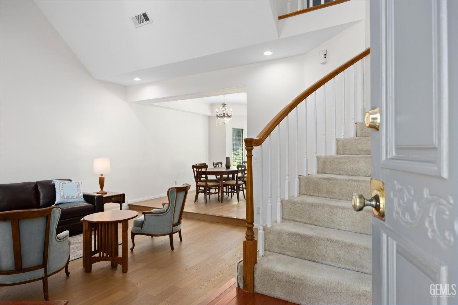 Undisclosed Address Bakersfield, CA 93309 - Photo 6 of 48 a view of dining room and livingroom with furniture wooden floor and a rug