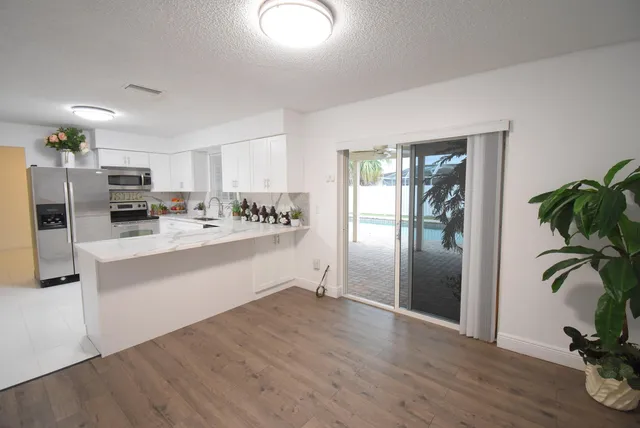 a kitchen with stainless steel appliances a refrigerator and a counter top space