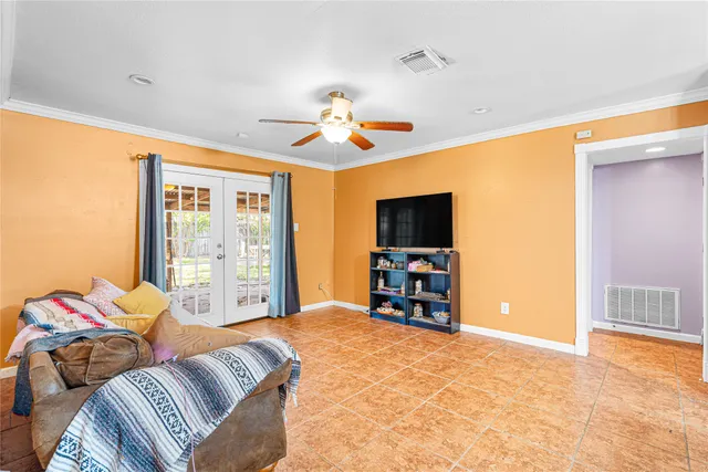 a bedroom with furniture and a flat screen tv