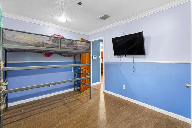 a view of room with wooden floor and flat screen tv