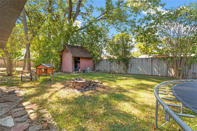 a backyard of a house with table and chairs