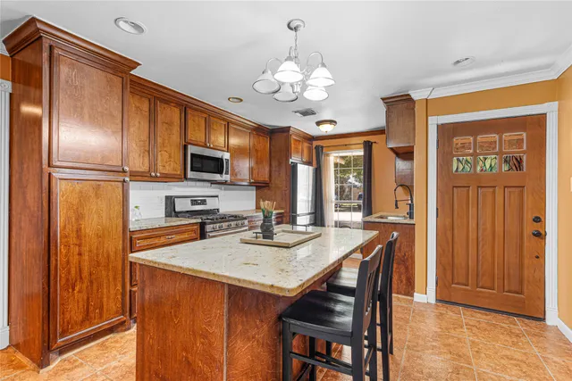 a kitchen with a refrigerator a stove and a microwave