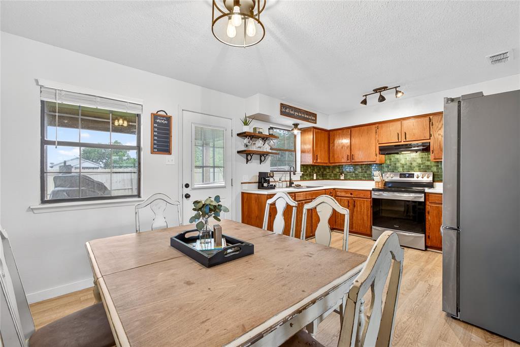 703 College Street Celeste, TX 75423 - Photo 10 of 29 a kitchen with a table chairs and a dining table