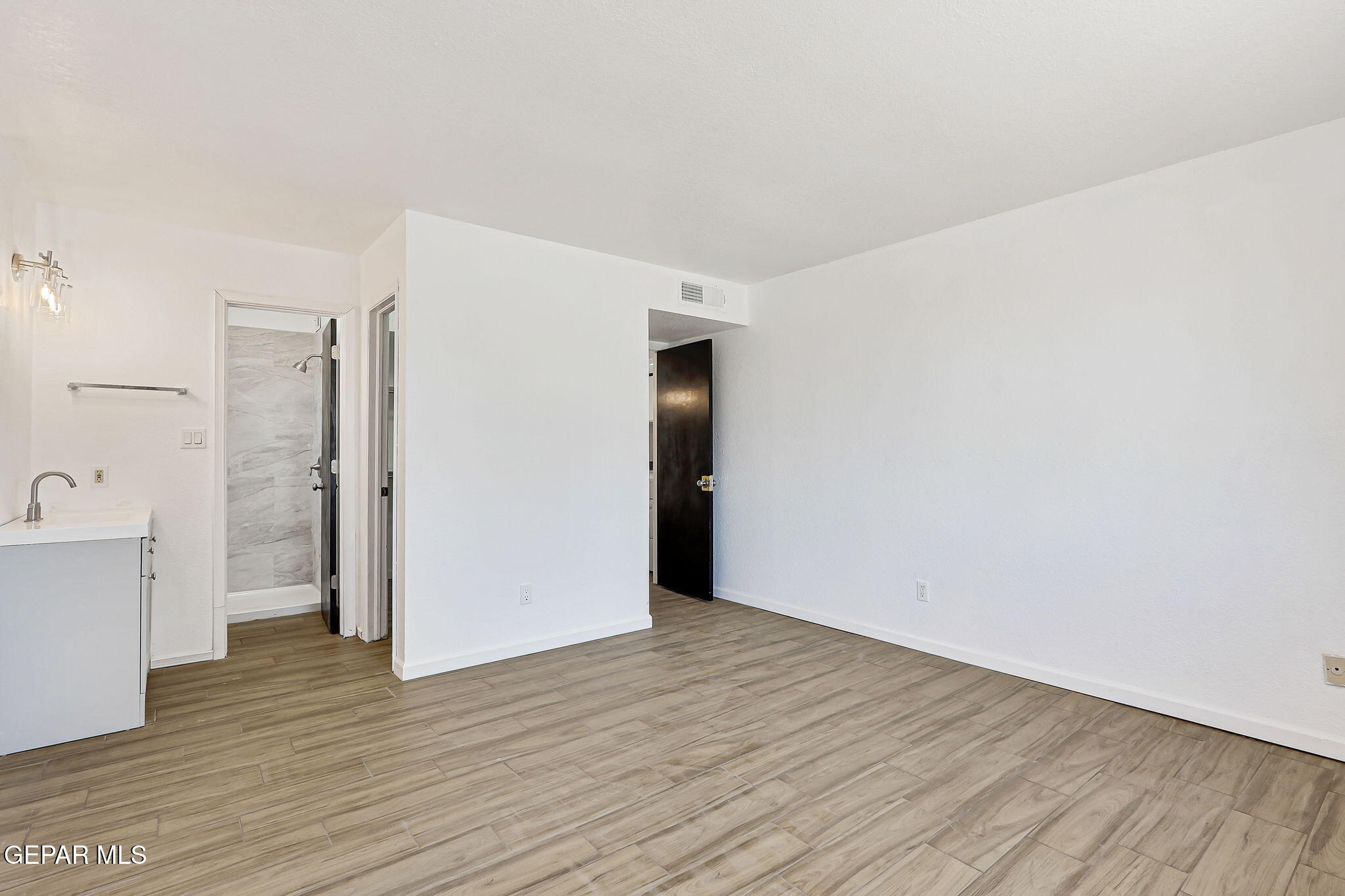 1053 Hillrise Court Las Cruces, NM 88011 - Photo 20 of 53 a view of a kitchen with wooden floor and white doors