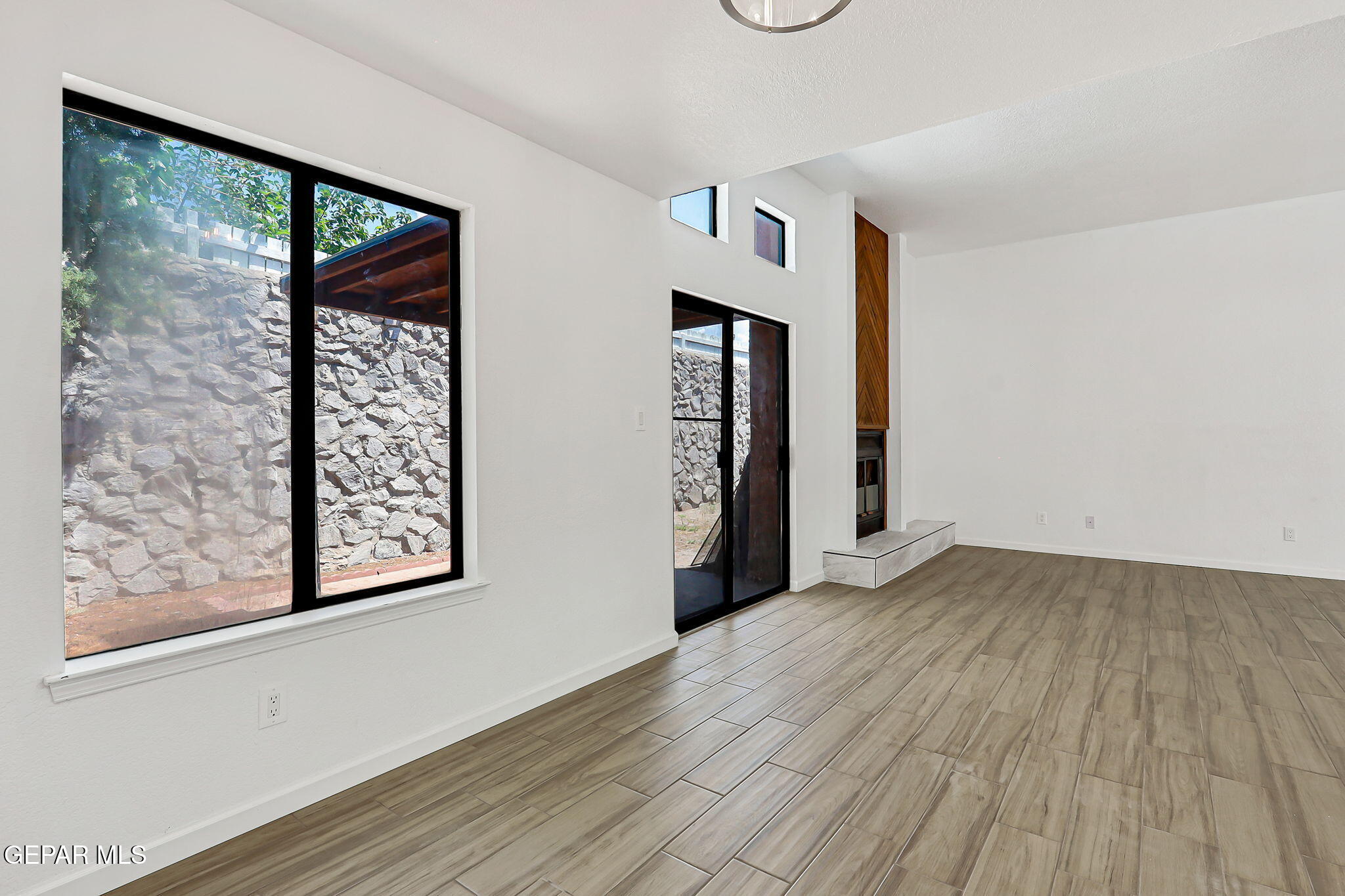 1053 Hillrise Court Las Cruces, NM 88011 - Photo 33 of 53 an empty room with wooden floor and windows