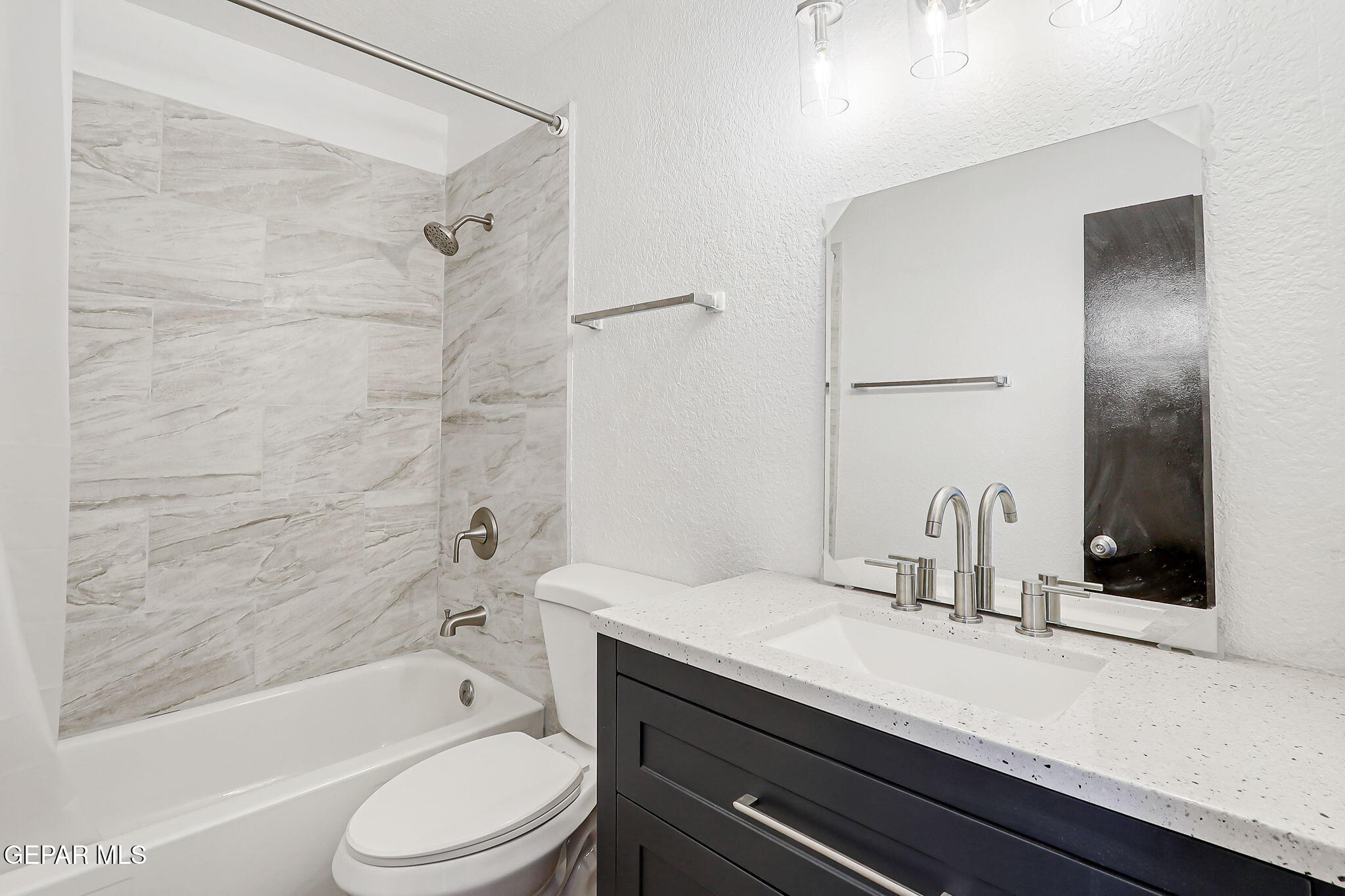 1053 Hillrise Court Las Cruces, NM 88011 - Photo 46 of 53 a bathroom with a granite countertop bathtub shower sink vanity mirror and toilet