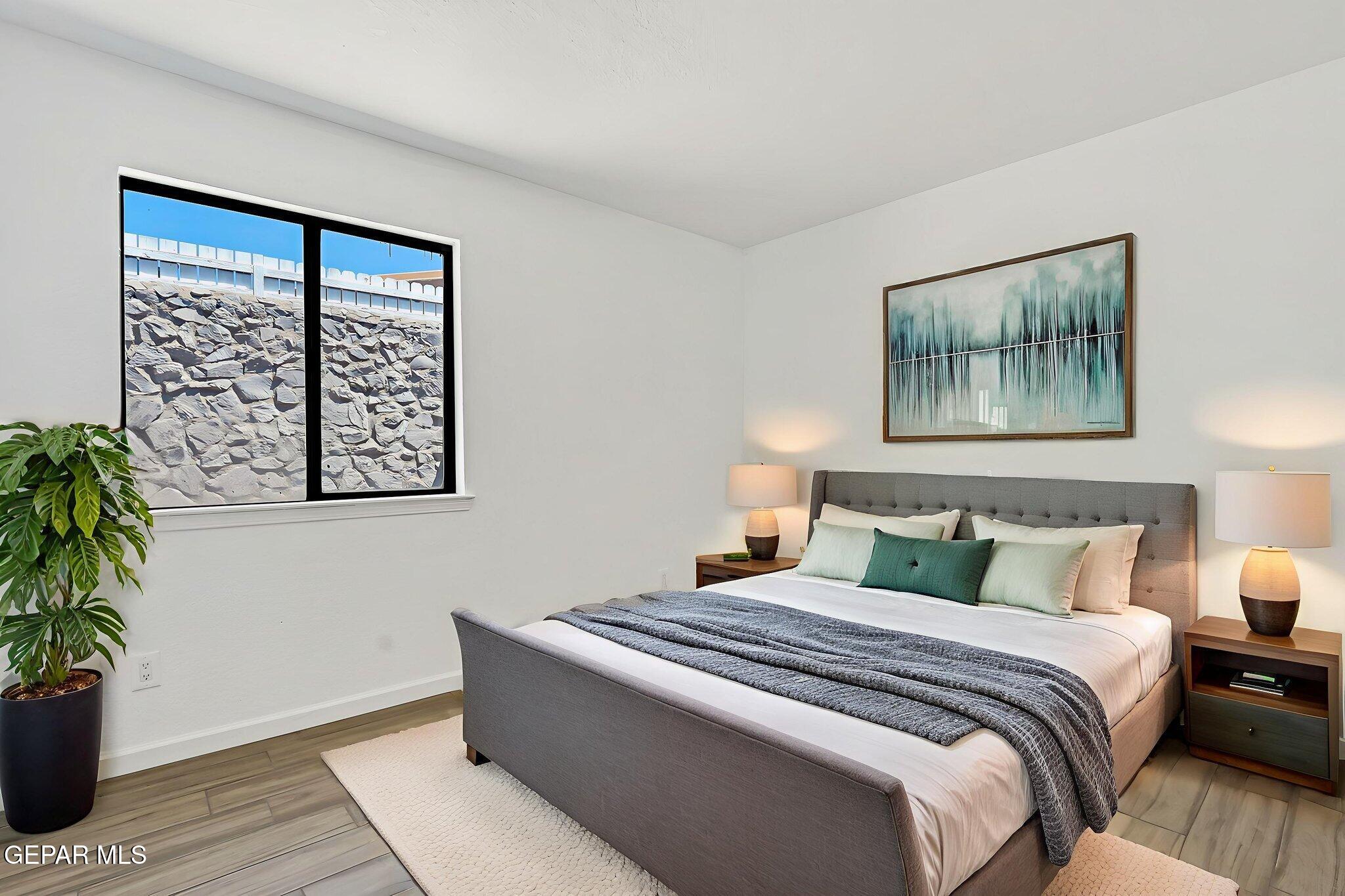 1053 Hillrise Court Las Cruces, NM 88011 - Photo 50 of 53 a bedroom with a large bed and a potted plant