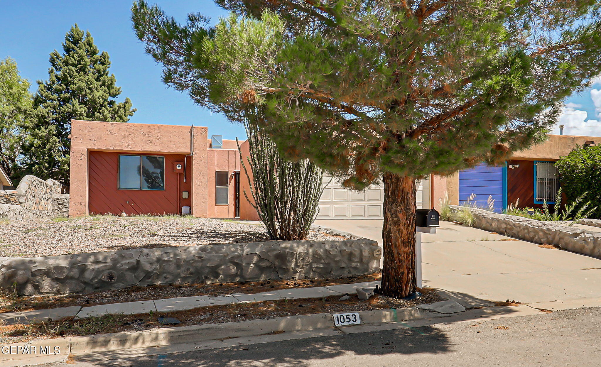 1053 Hillrise Court Las Cruces, NM 88011 - Photo 9 of 53 a front view of a house with a tree