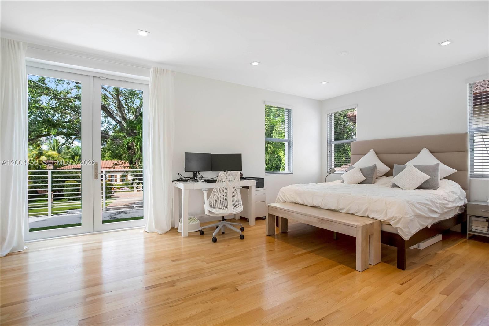 152 Southwest 20th Road Miami, FL 33129 - Photo 11 of 22 a spacious bedroom with a bed and wooden floor