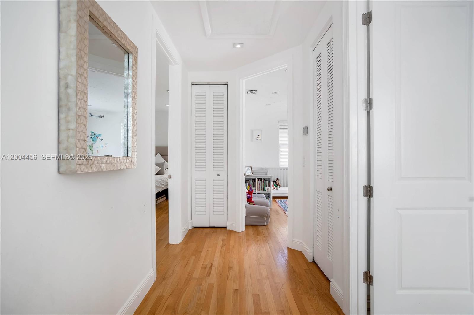152 Southwest 20th Road Miami, FL 33129 - Photo 13 of 22 a view of a hallway with wooden floor and a bathroom