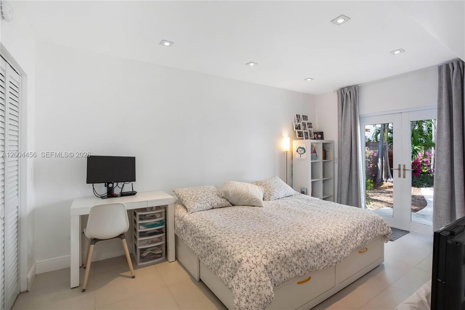 152 Southwest 20th Road Miami, FL 33129 - Photo 15 of 22 a bedroom with a bed and a chair