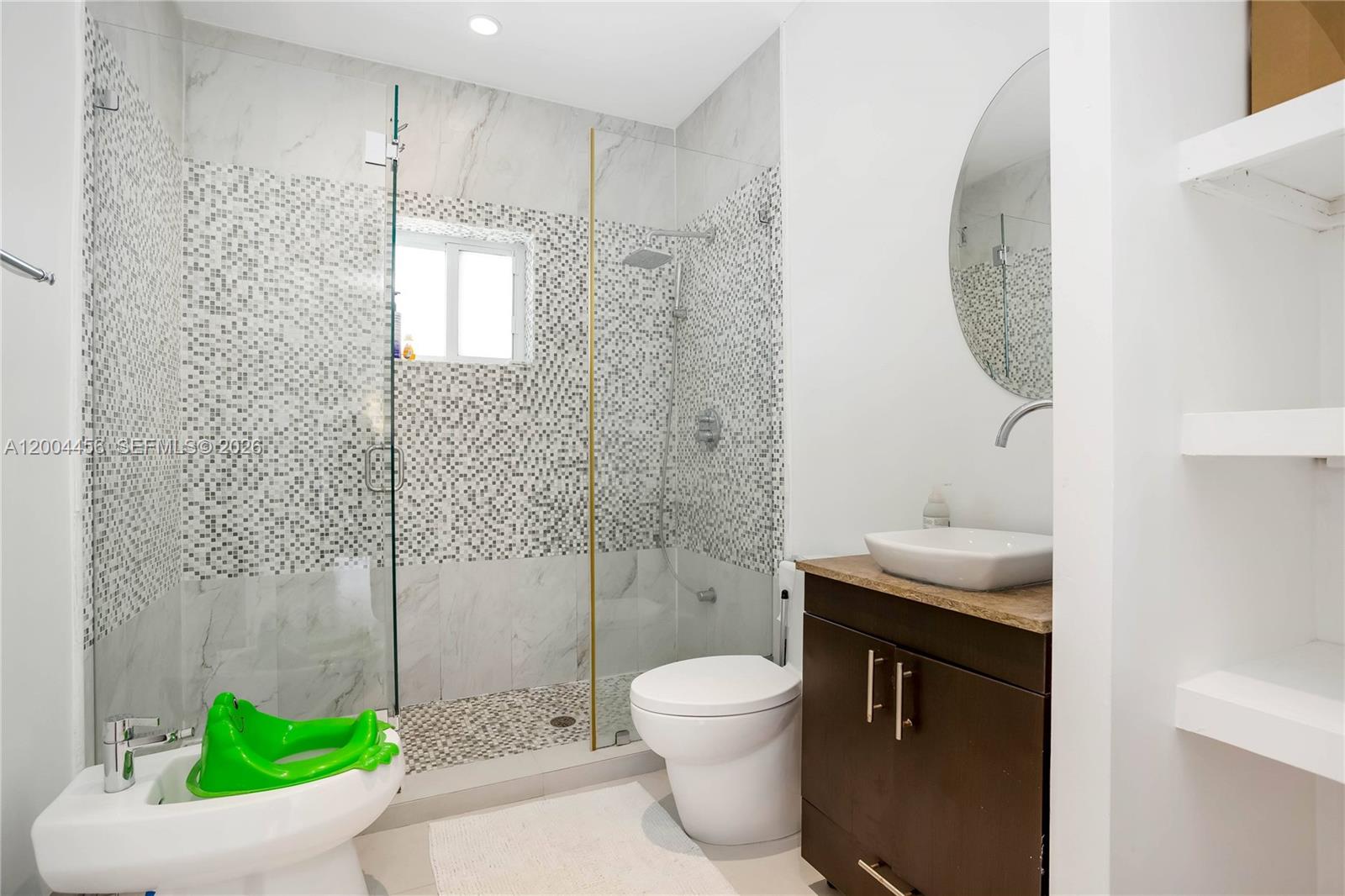 152 Southwest 20th Road Miami, FL 33129 - Photo 16 of 22 a bathroom with a granite countertop sink a toilet a shower and a mirror