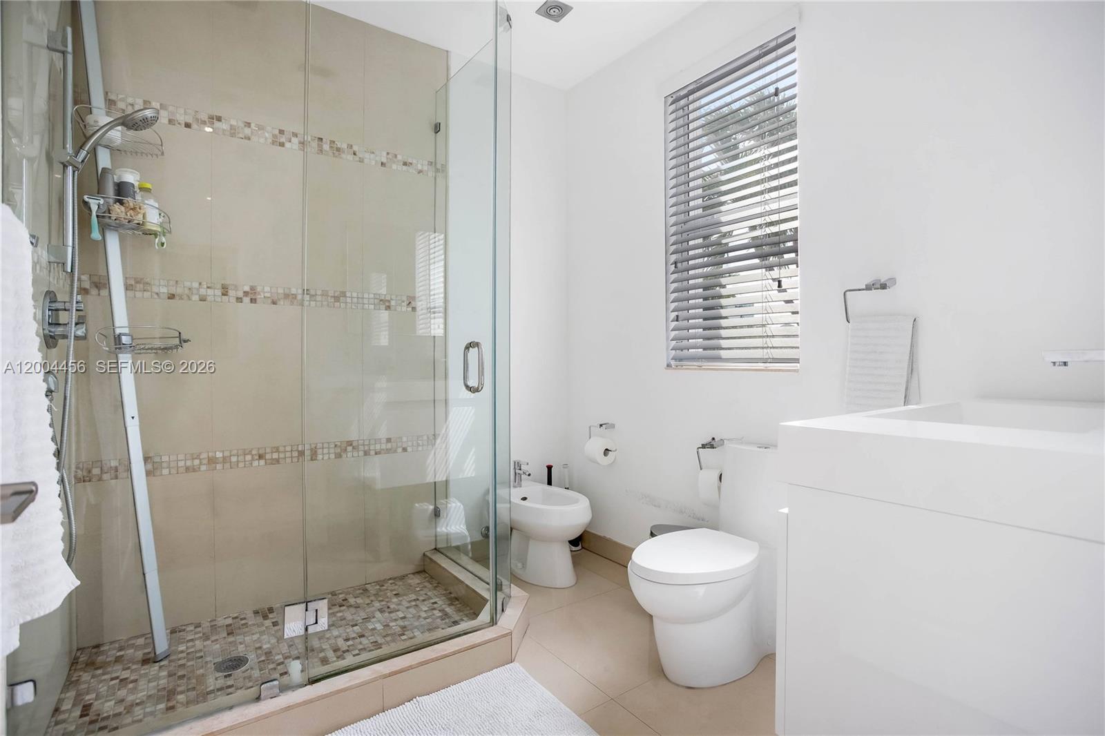 152 Southwest 20th Road Miami, FL 33129 - Photo 17 of 22 a bathroom with a toilet sink and shower