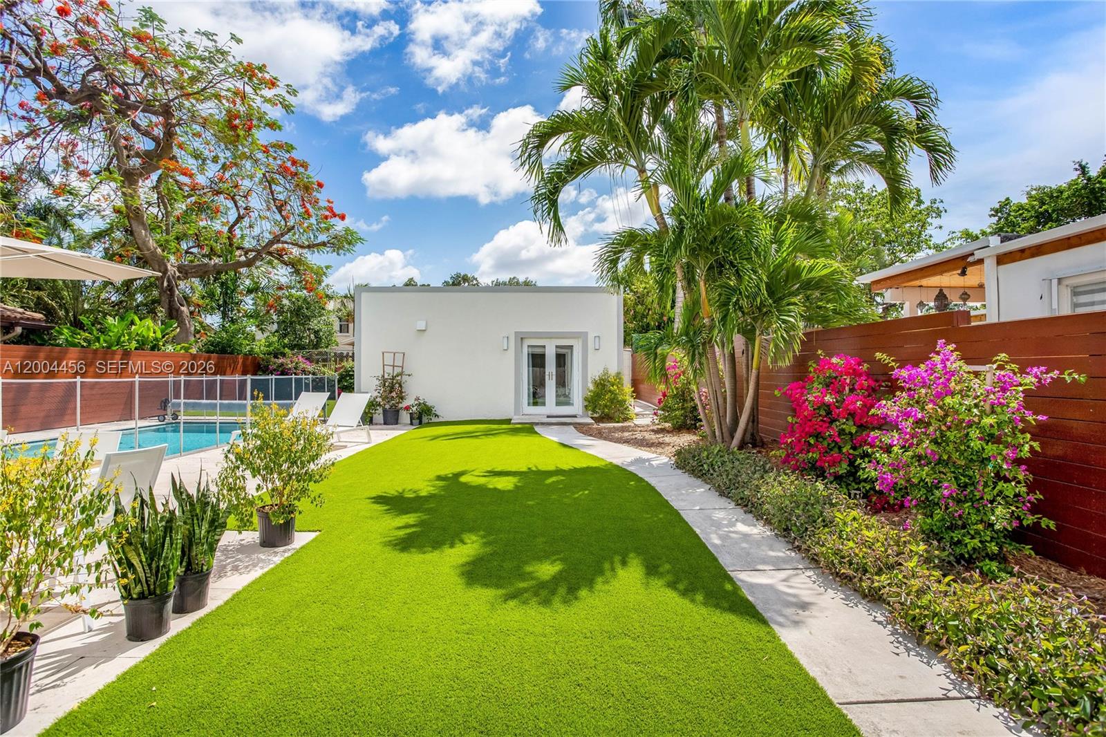 152 Southwest 20th Road Miami, FL 33129 - Photo 19 of 22 a view of a house with swimming pool and a garden