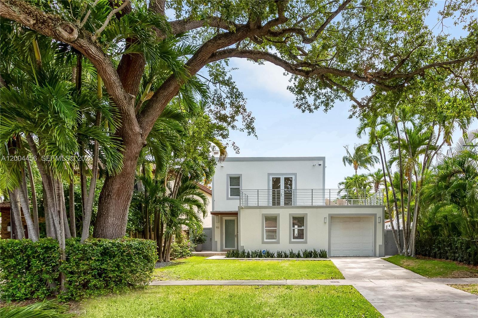152 Southwest 20th Road Miami, FL 33129 - Photo 2 of 22 a view of house with a big yard plants and large trees