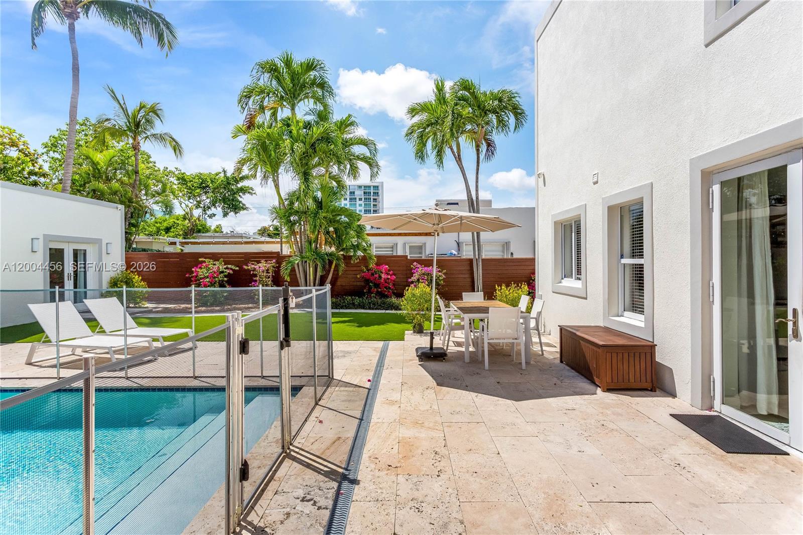 152 Southwest 20th Road Miami, FL 33129 - Photo 22 of 22 a view of a patio with table and chairs potted plants and palm tree