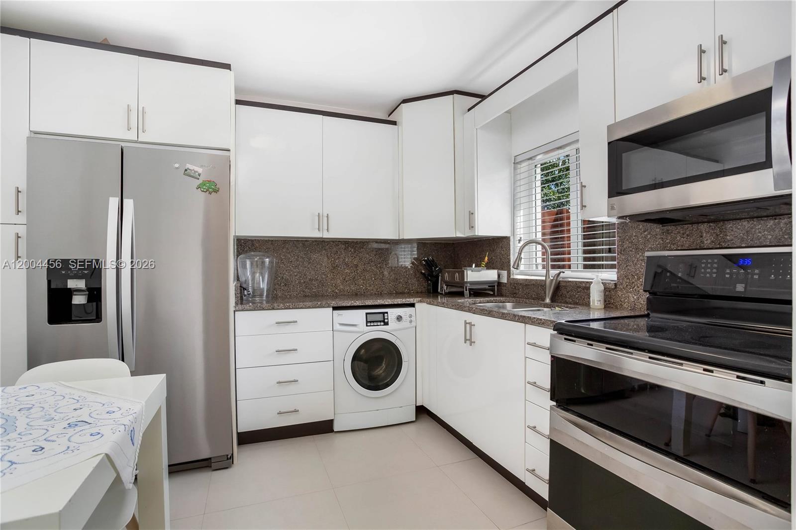 152 Southwest 20th Road Miami, FL 33129 - Photo 10 of 22 a kitchen with a refrigerator a stove and microwave