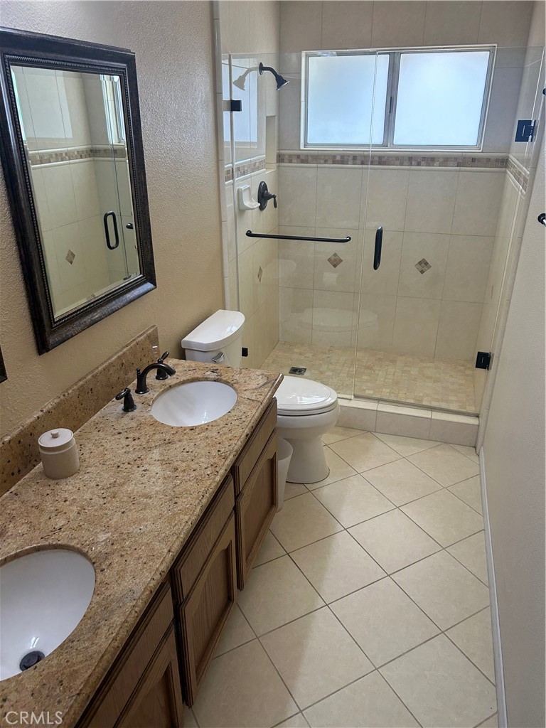 20187 Itasca Road Apple Valley, CA 92308 - Photo 9 of 35 a bathroom with a granite countertop sink and a mirror
