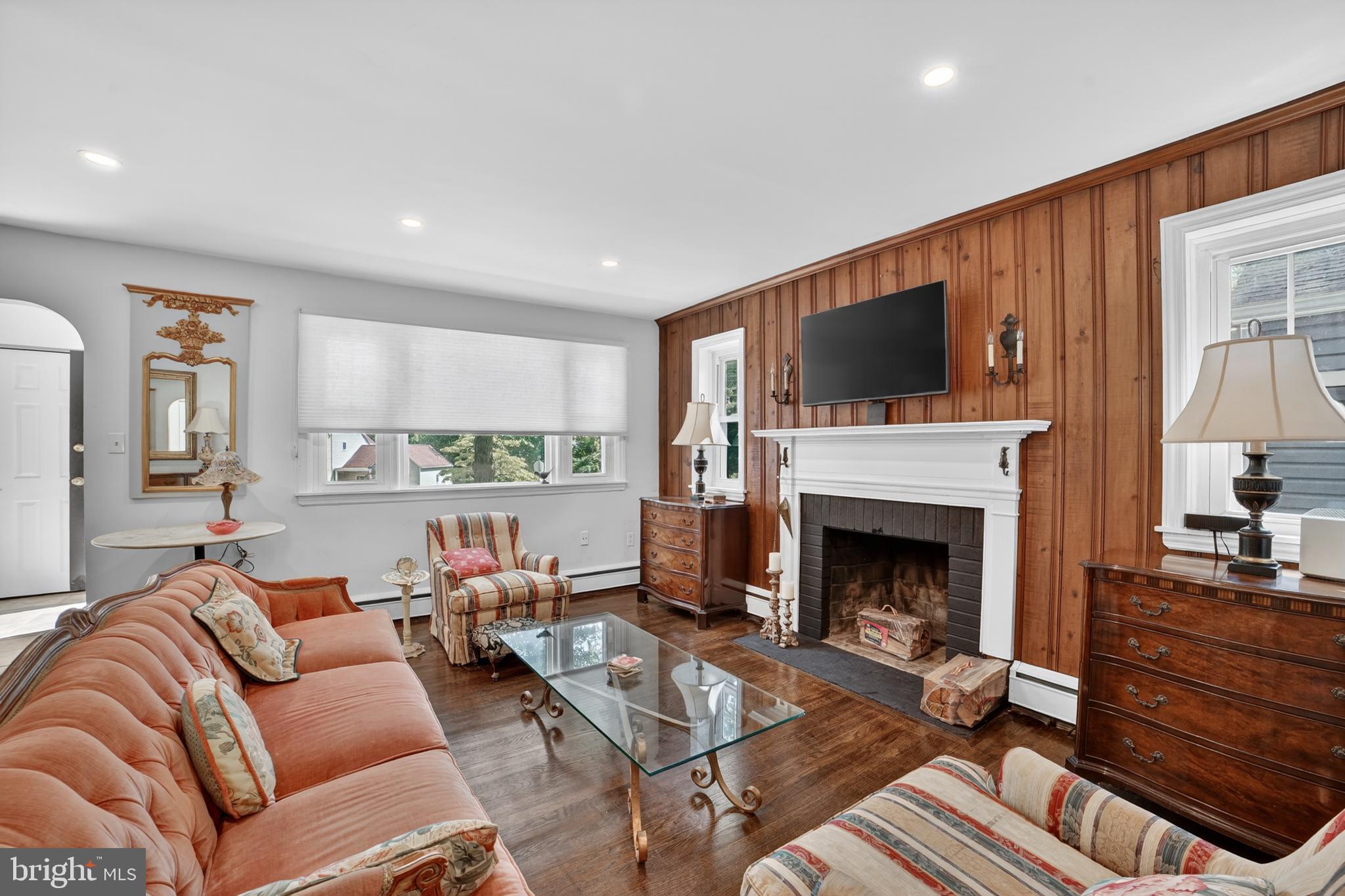 305 Irish Road Berwyn, PA 19312 - Photo 5 of 34 a living room with furniture a flat screen tv and a fireplace