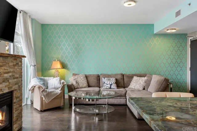 a living room with furniture a fireplace and a flat screen tv