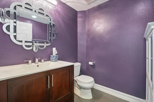 a bathroom with a sink mirror toilet and bathtub