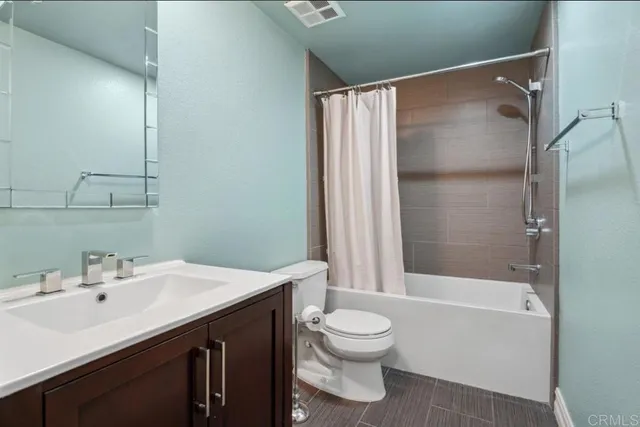 a bedroom with a bed and a large mirror