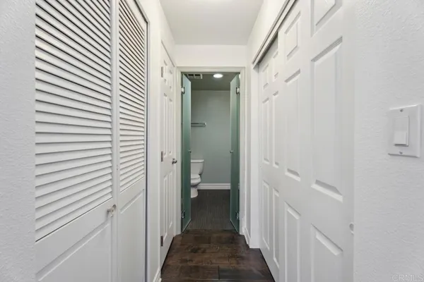 a bathroom with a toilet a sink a shower and mirror