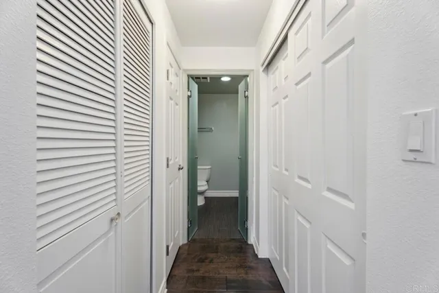 a bathroom with a toilet a sink a shower and mirror