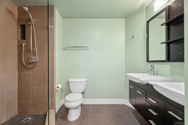 a bathroom with a toilet and a shower