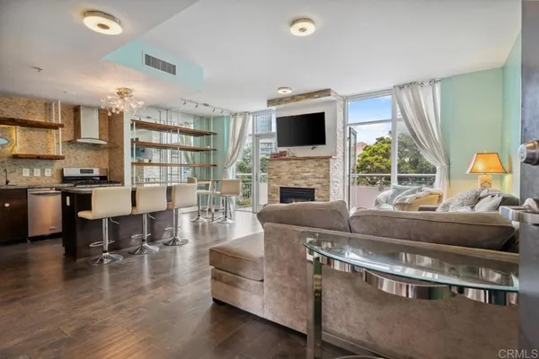 a living room with furniture fireplace and flat screen tv