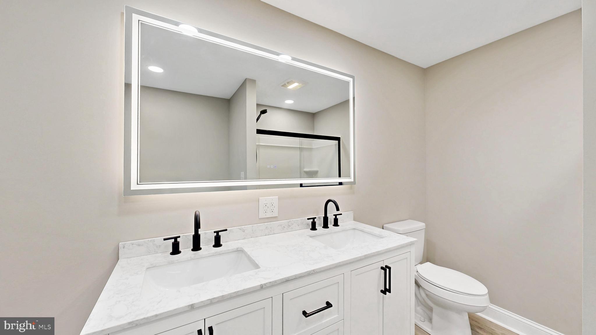 3318 Underwoods Corner Road Clayton, DE 19938 - Photo 11 of 54 a bathroom with a toilet a sink a mirror and vanity