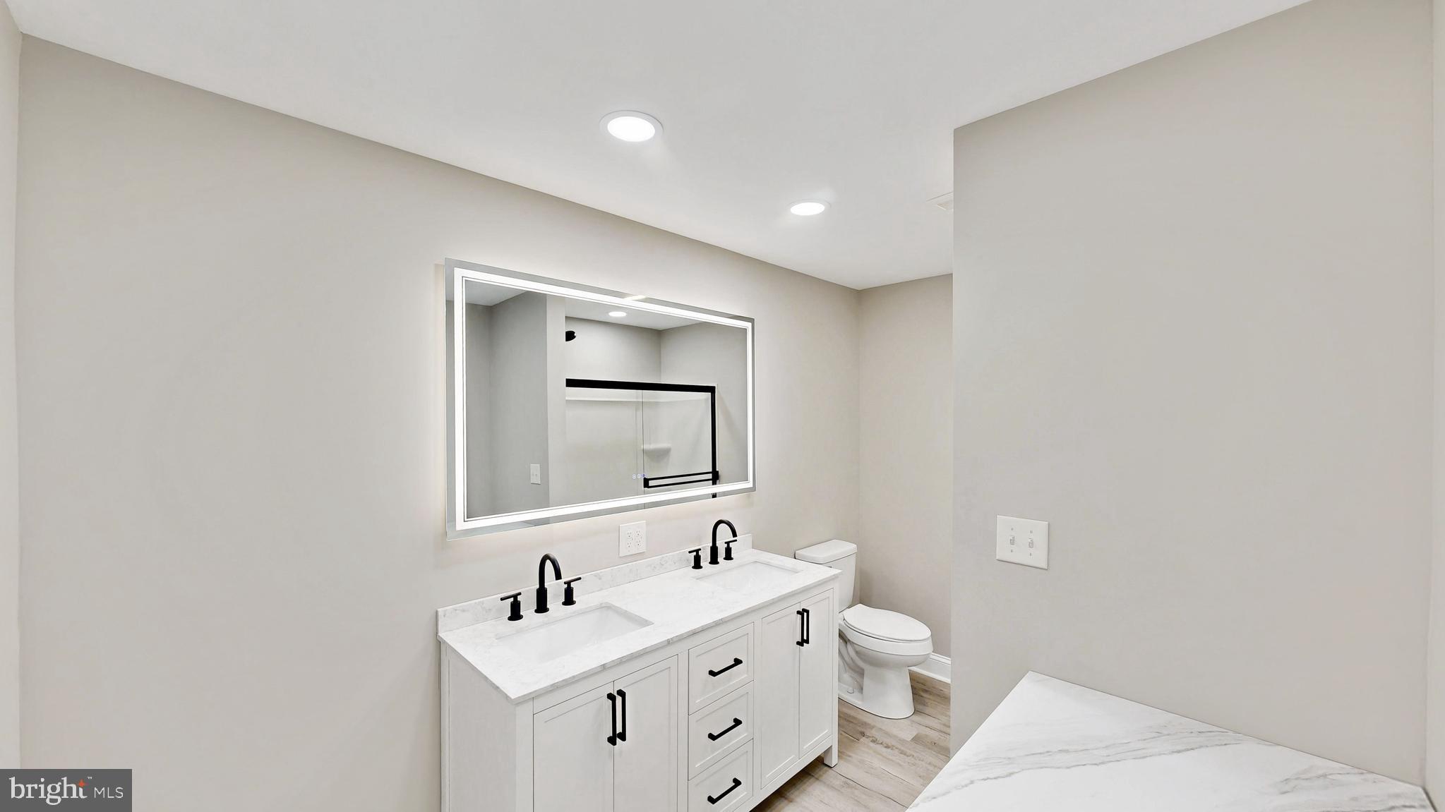 3318 Underwoods Corner Road Clayton, DE 19938 - Photo 12 of 54 a bathroom with a toilet sink and mirror