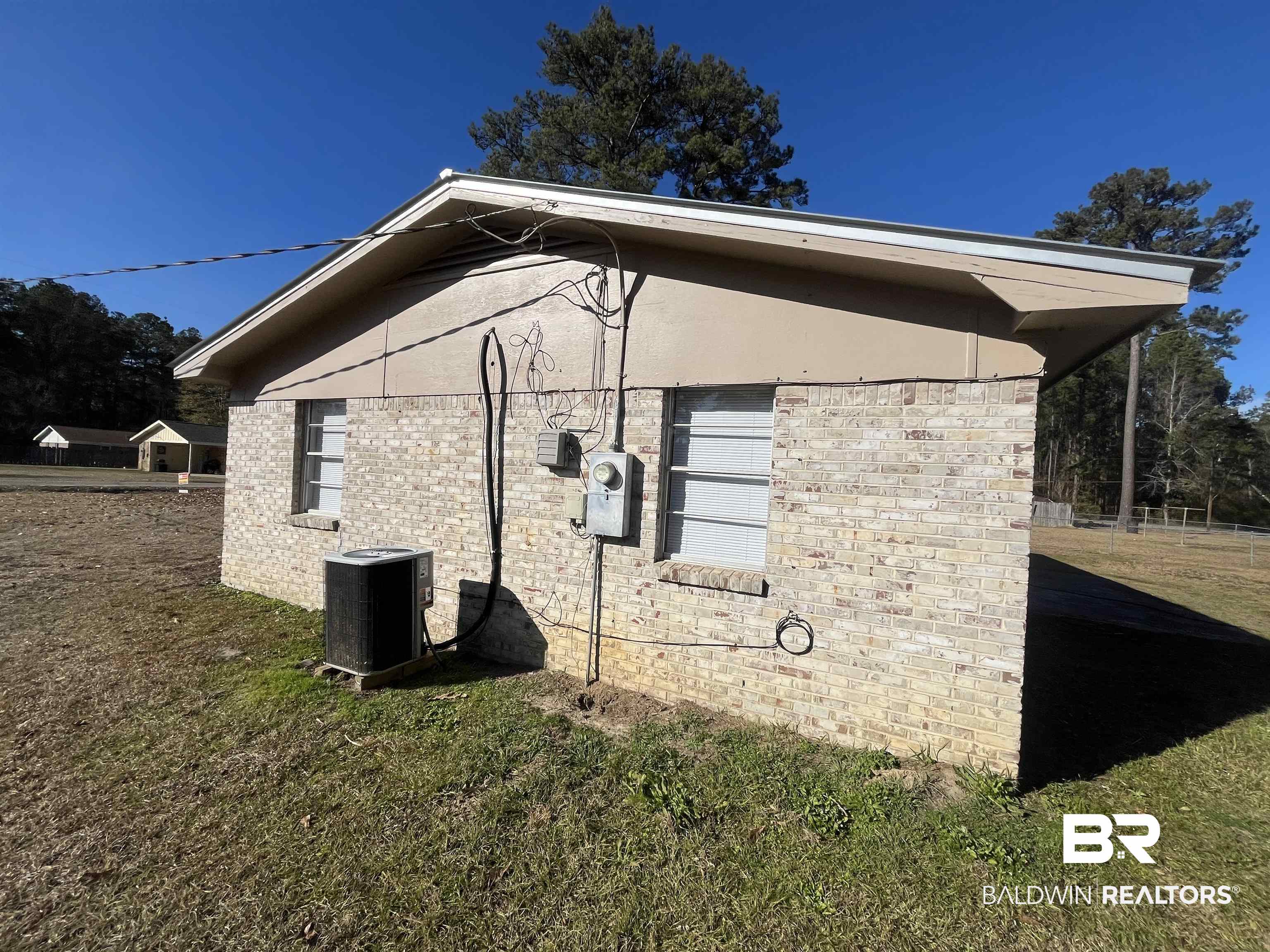 103 Roadway Street Brewton, AL 36426 - Photo 4 of 13 View of side of home featuring a yard and central air condition unit